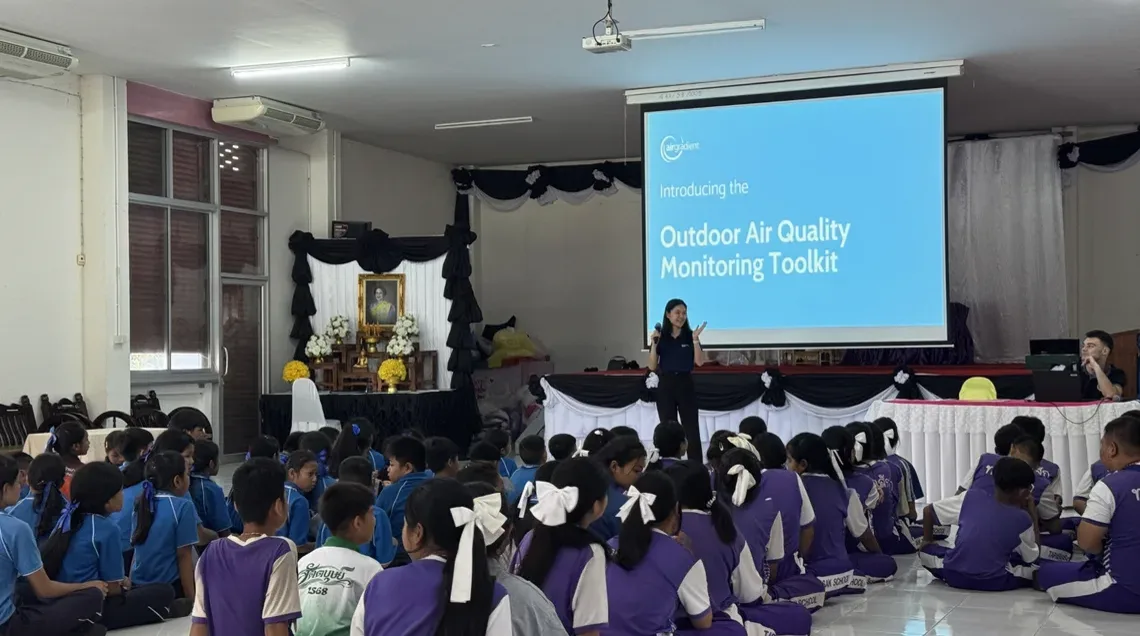 Community members gathering around an outdoor air quality display.